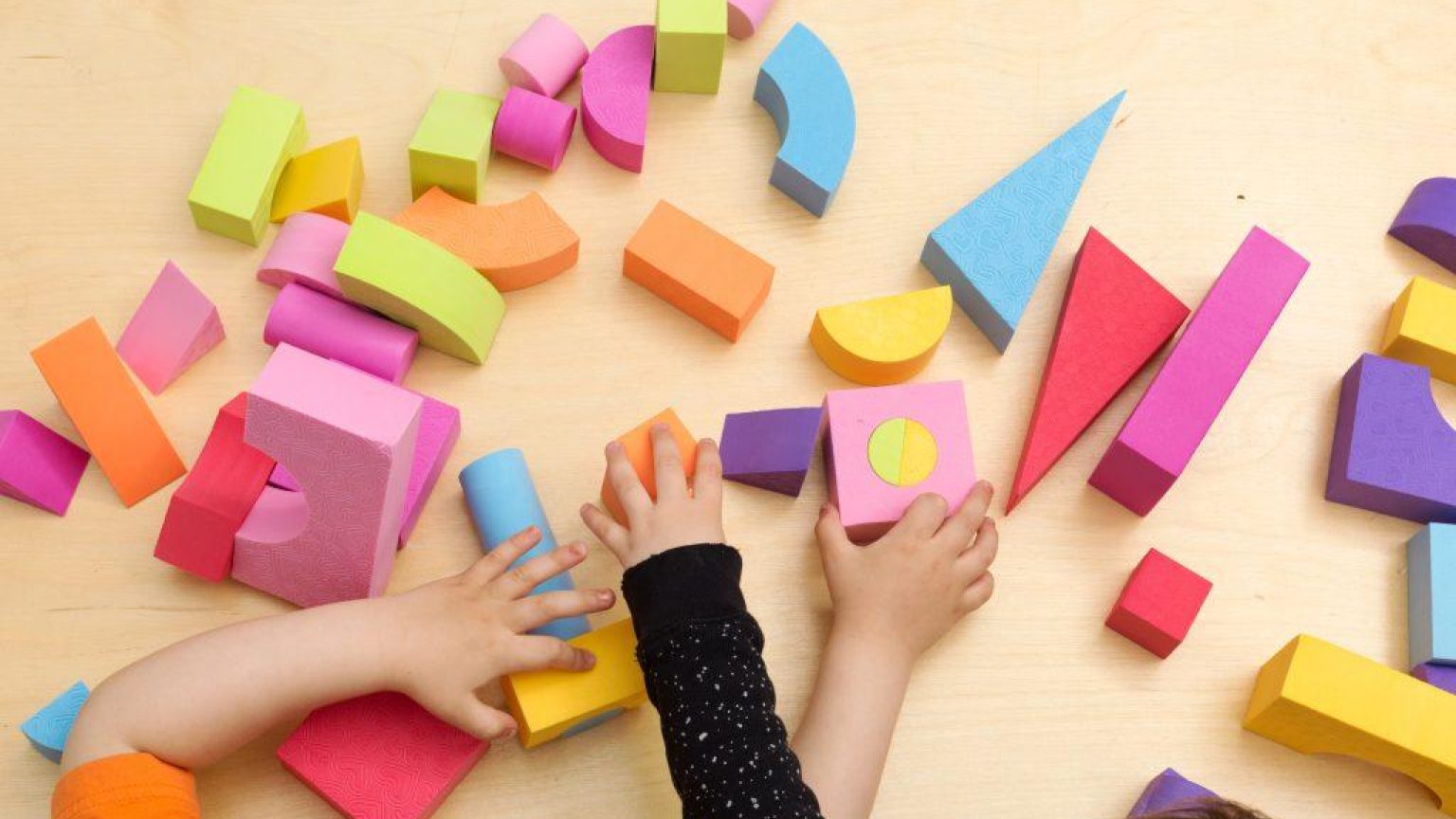 Children sharing and playing with toys 1024x683
