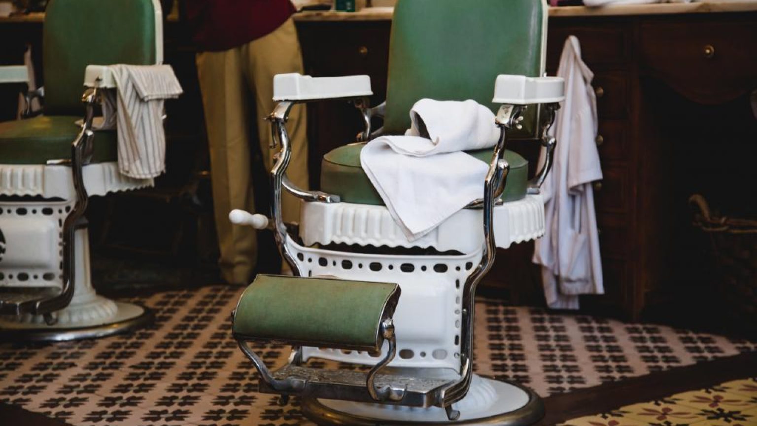 Pair of green and white chairs in barbershop 1024x683