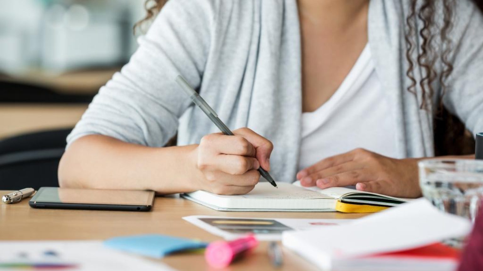 Woman at work taking notes 1024x683